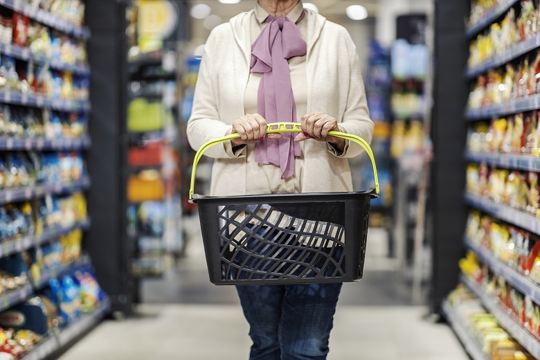 senior woman holding empty shopping basket