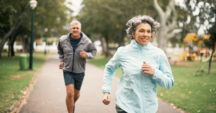 Elderly couple jogging in the park.