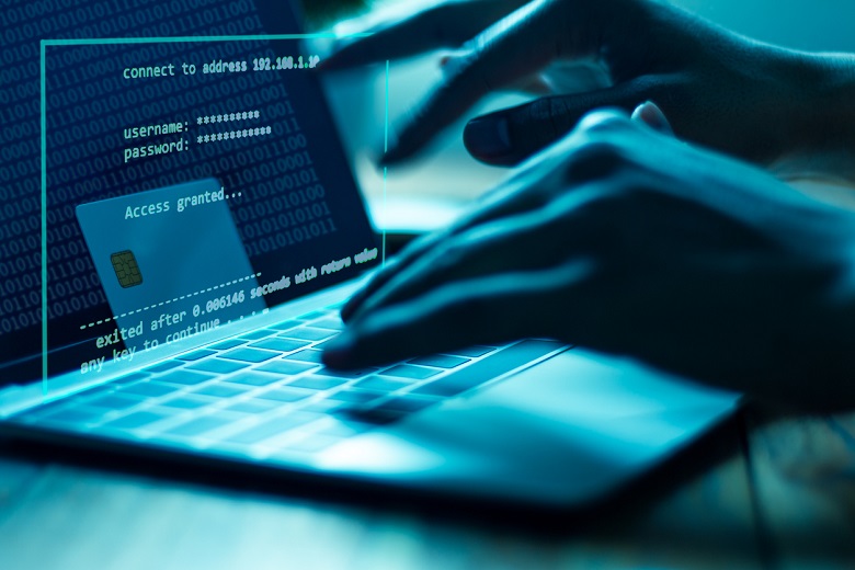 computer hacker hands on laptop
