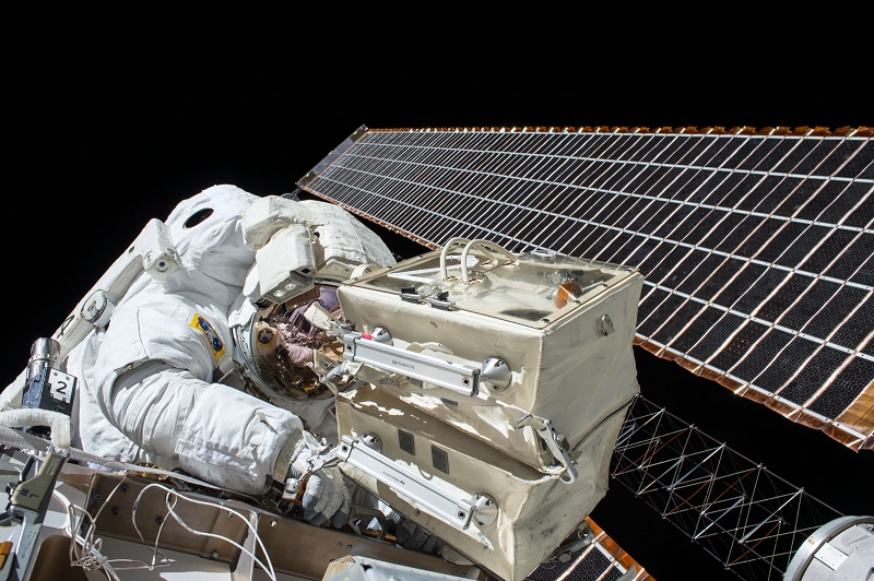 Astronaut repairing a satellite in space